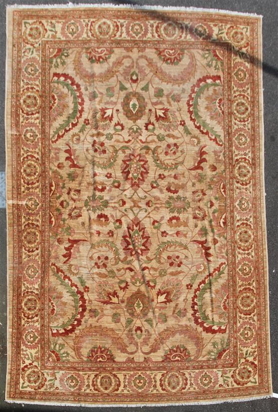 A large Persian carpet, 16ft 11in by 11ft 11in.